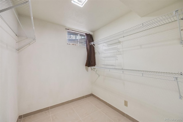 spacious closet with light tile patterned floors