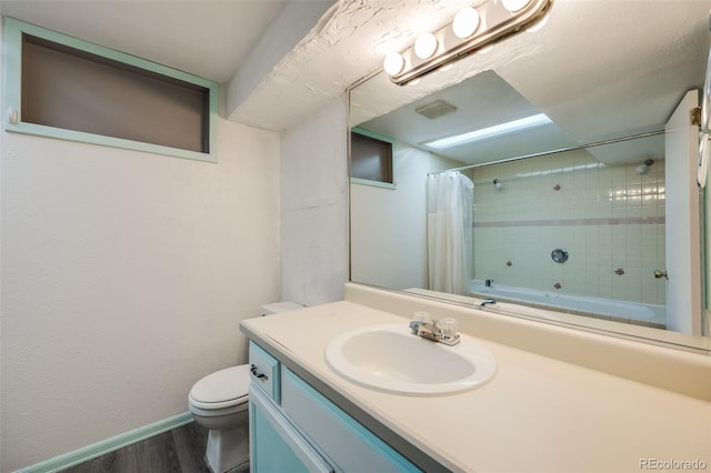 full bathroom featuring hardwood / wood-style floors, vanity, toilet, and shower / bath combination with curtain