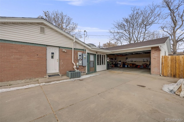 exterior space with a garage and central AC unit