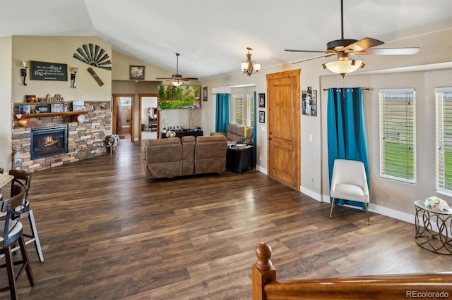 living room featuring dark wood-type flooring, ceiling fan, vaulted ceiling, and a fireplace