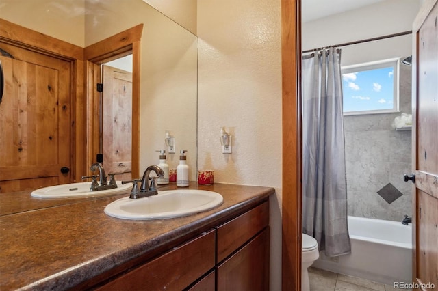 full bathroom featuring shower / tub combo with curtain, tile patterned floors, vanity, and toilet