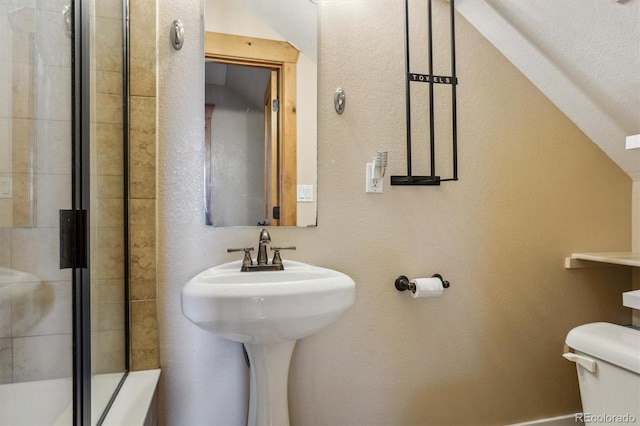 bathroom with vaulted ceiling, toilet, and an enclosed shower