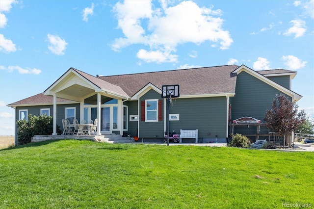 view of front of house with a patio and a front yard