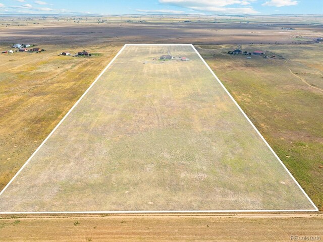 birds eye view of property with a rural view