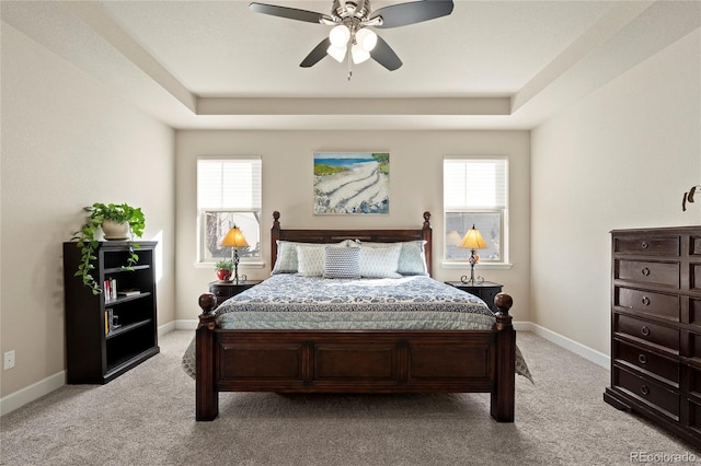 bedroom featuring multiple windows, light carpet, and baseboards