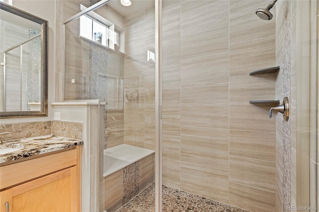 bathroom featuring a stall shower and vanity