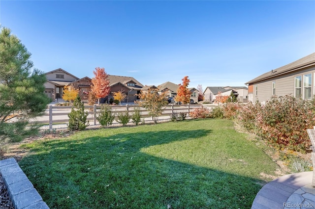 view of yard with fence and a residential view