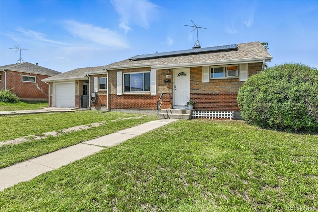 2441 E 93rd Pl, Thornton, CO 80229 - view of front of home with an attached garage, roof mounted solar panels, a front lawn, and brick siding