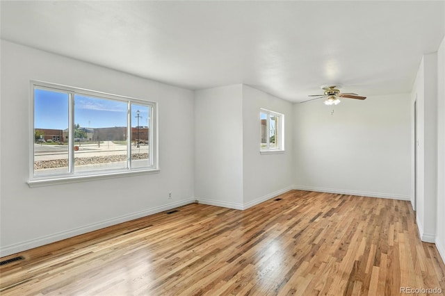 2441 E 93rd Pl, Thornton, CO 80229 - spare room featuring healthy amount of natural light, light wood finished floors, and ceiling fan