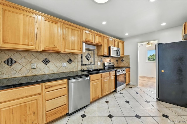 2441 E 93rd Pl, Thornton, CO 80229 - kitchen with stainless steel appliances, tasteful backsplash, recessed lighting, light tile patterned flooring, and ceiling fan