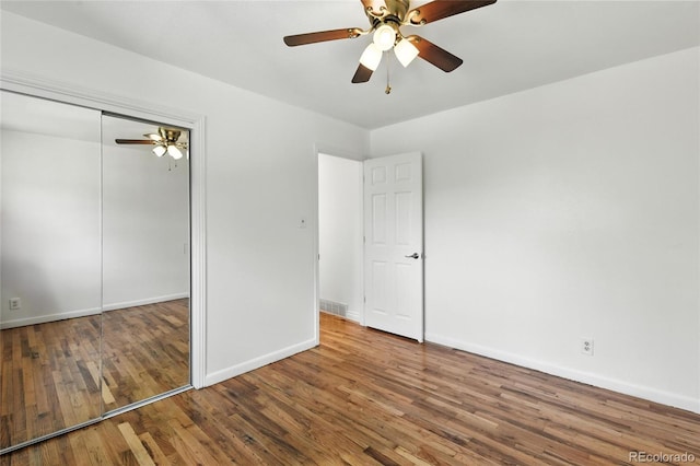 2441 E 93rd Pl, Thornton, CO 80229 - unfurnished bedroom with wood finished floors, a closet, and a ceiling fan