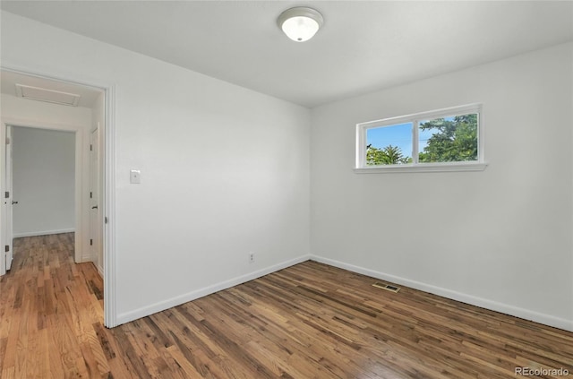 2441 E 93rd Pl, Thornton, CO 80229 - empty room with wood finished floors and attic access