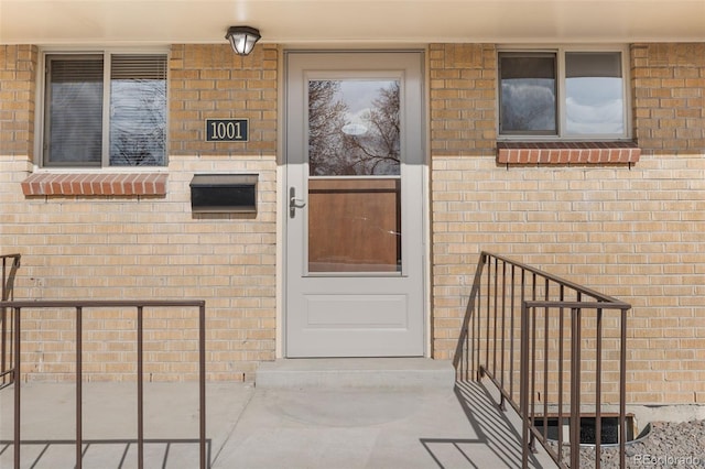 property entrance featuring brick siding