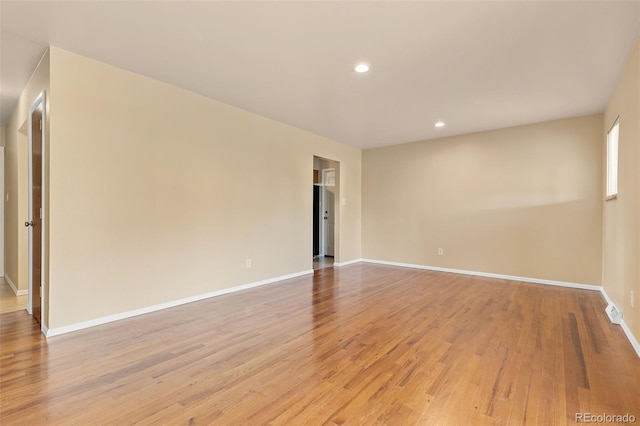 unfurnished room featuring recessed lighting, baseboards, and light wood finished floors