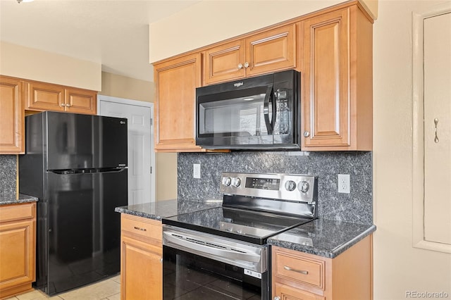 kitchen with dark stone countertops, decorative backsplash, black appliances, and light tile patterned flooring