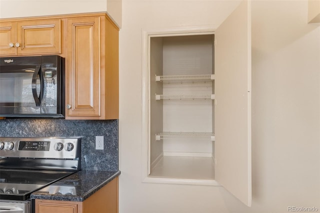 kitchen with stainless steel electric range oven, backsplash, dark stone countertops, and black microwave