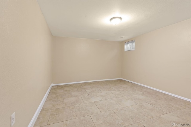 unfurnished room featuring baseboards