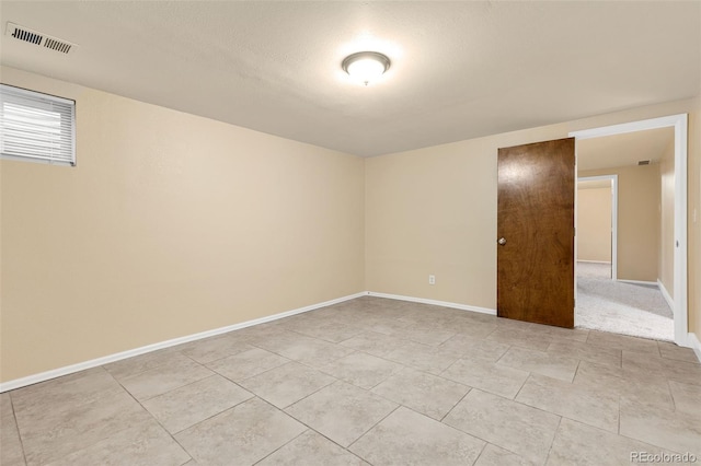 empty room with visible vents and baseboards