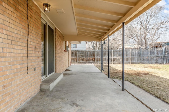 view of patio with visible vents and fence