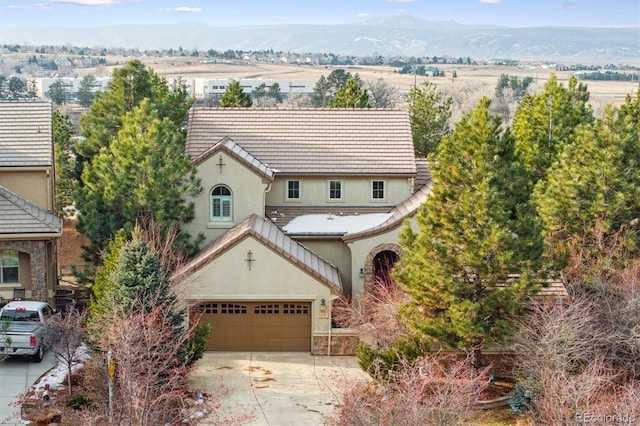 view of front of house with a mountain view and a garage