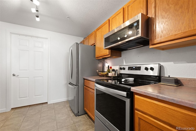 kitchen featuring a textured ceiling and appliances with stainless steel finishes