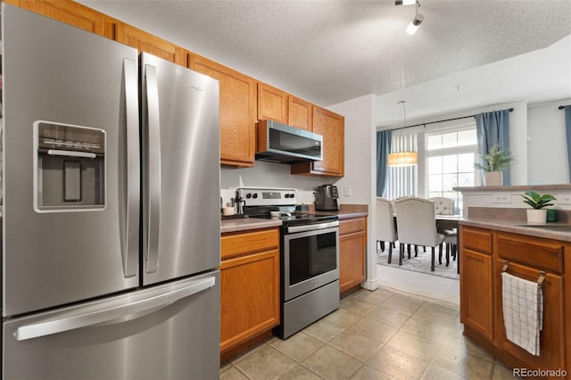 kitchen featuring a textured ceiling and appliances with stainless steel finishes