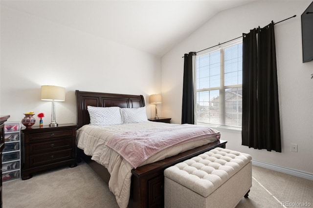 bedroom with light carpet and vaulted ceiling