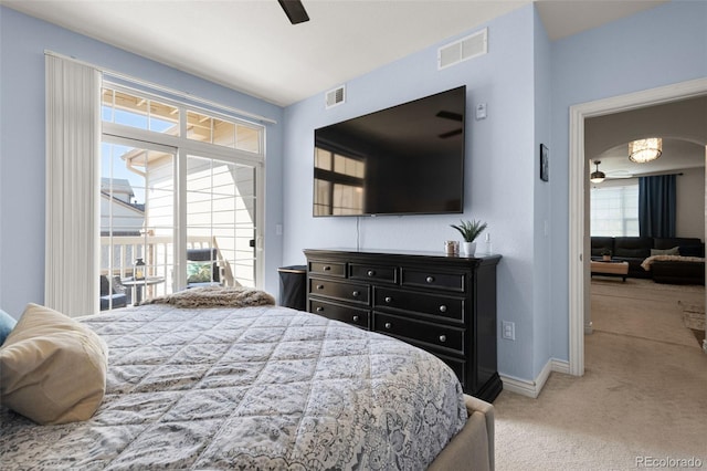 carpeted bedroom featuring ceiling fan and multiple windows