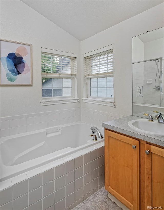 2500 Lexington St, Lafayette, CO 80026 - full bathroom with lofted ceiling, a stall shower, plenty of natural light, vanity, and a garden tub