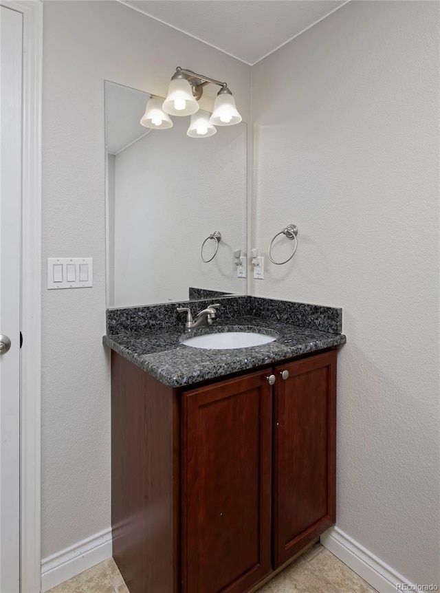 2500 Lexington St, Lafayette, CO 80026 - bathroom featuring vanity, baseboards, a chandelier, and tile patterned floors