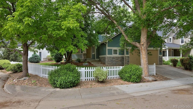2500 Lexington St, Lafayette, CO 80026 - view of property hidden behind natural elements with driveway, stone siding, and a fenced front yard