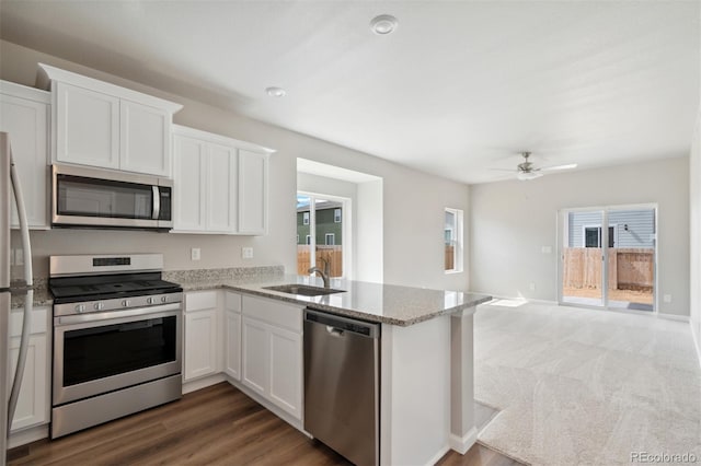 kitchen with sink, appliances with stainless steel finishes, and white cabinets