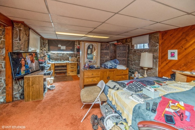 carpeted bedroom with wood walls