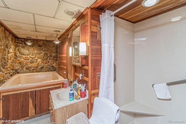 bathroom with shower / tub combo, vanity, and a drop ceiling