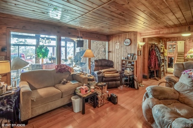 living room featuring wood walls, wood ceiling, and light wood-type flooring