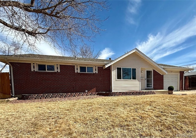 ranch-style home with a front yard, brick siding, fence, and an attached garage