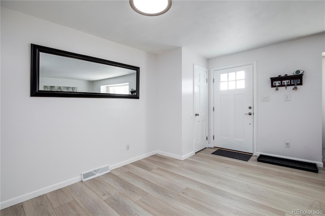 entryway with visible vents, baseboards, and wood finished floors