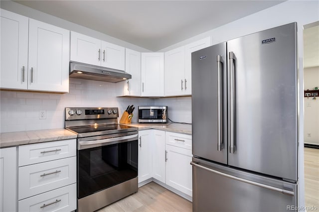 kitchen with stainless steel appliances, light wood-type flooring, white cabinetry, and under cabinet range hood