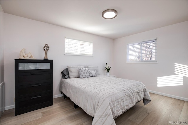 bedroom featuring light wood-style flooring and baseboards