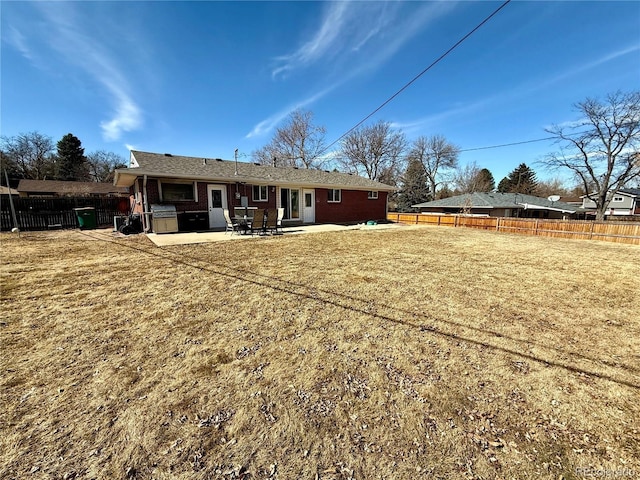 back of property featuring a patio area, a fenced backyard, and brick siding