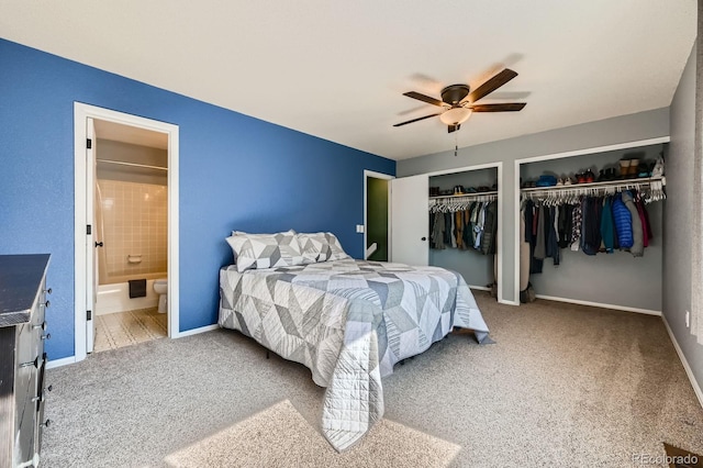 bedroom with multiple closets, carpet, baseboards, and ensuite bath