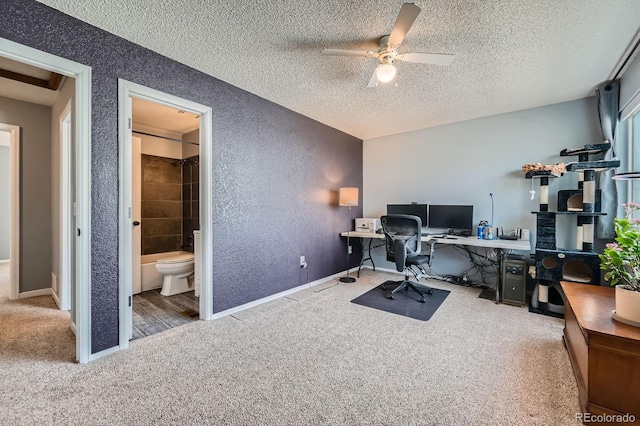 office space featuring carpet, ceiling fan, a textured ceiling, and a textured wall