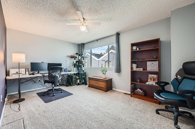 office with carpet flooring, ceiling fan, a textured ceiling, and baseboards