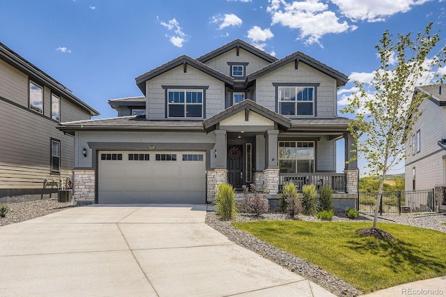 15210 W Eastman Ave, Morrison, CO 80465 - craftsman house featuring stone siding, a porch, driveway, and a garage