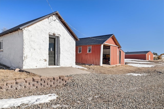 rear view of house with an outdoor structure