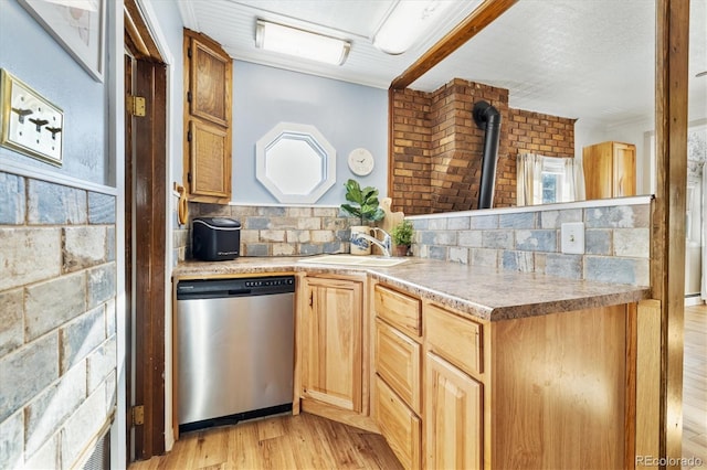 kitchen with stainless steel dishwasher, light wood-type flooring, backsplash, and sink