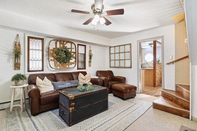 living room with ceiling fan and a baseboard heating unit