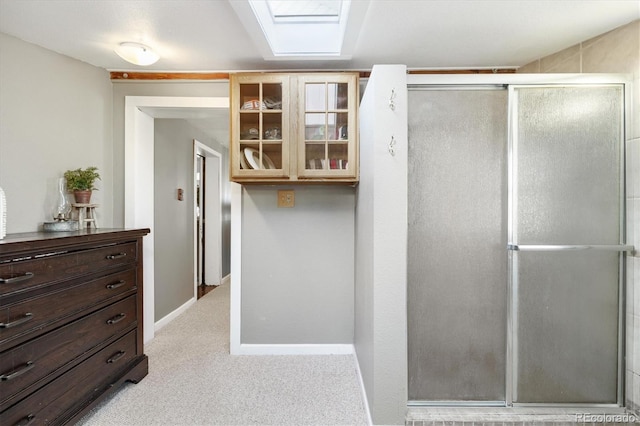 bathroom with a shower with door