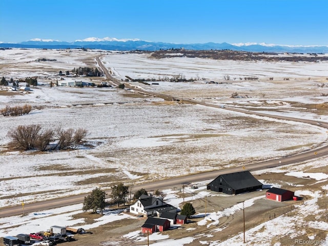 snowy aerial view with a mountain view