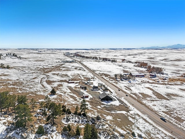 snowy aerial view featuring a mountain view